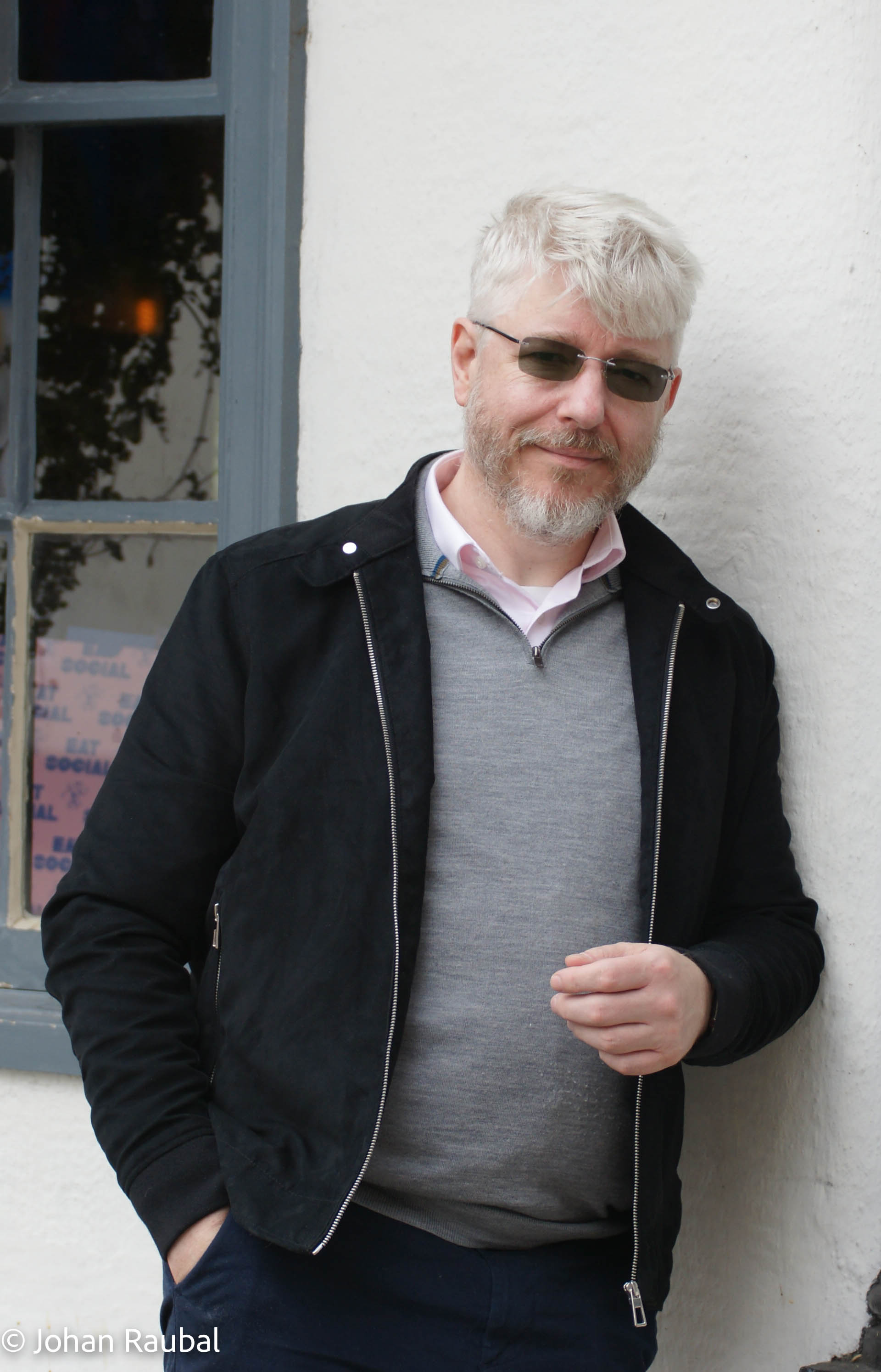 Johan Raubal standing beside a window